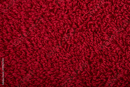 Photography red fabric and texture concept - close up of a towel terrycloth or terry textile