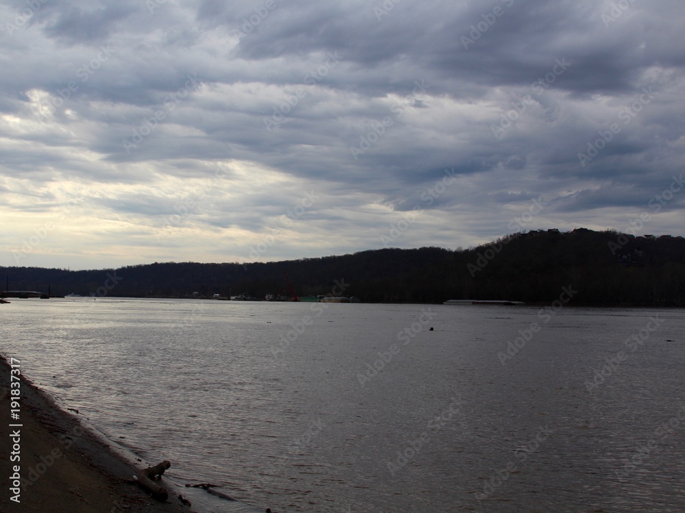Th overcast skies over the river in the park. Th overcast skies over the river in the park.