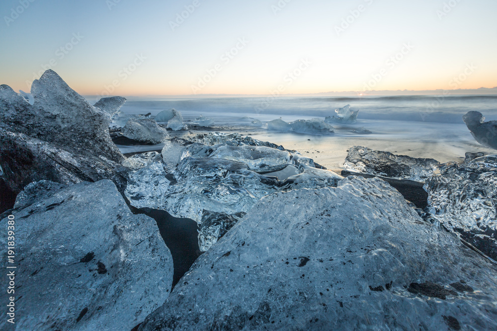The Jokulsarlon glacier lagoon and ice beach Diamond Beach lagoon iceberg Jokulsarlon at sunrise