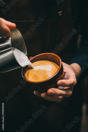 how to make latte art by barista focus in milk and coffee photo