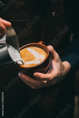 how to make latte art by barista focus in milk and coffee photo