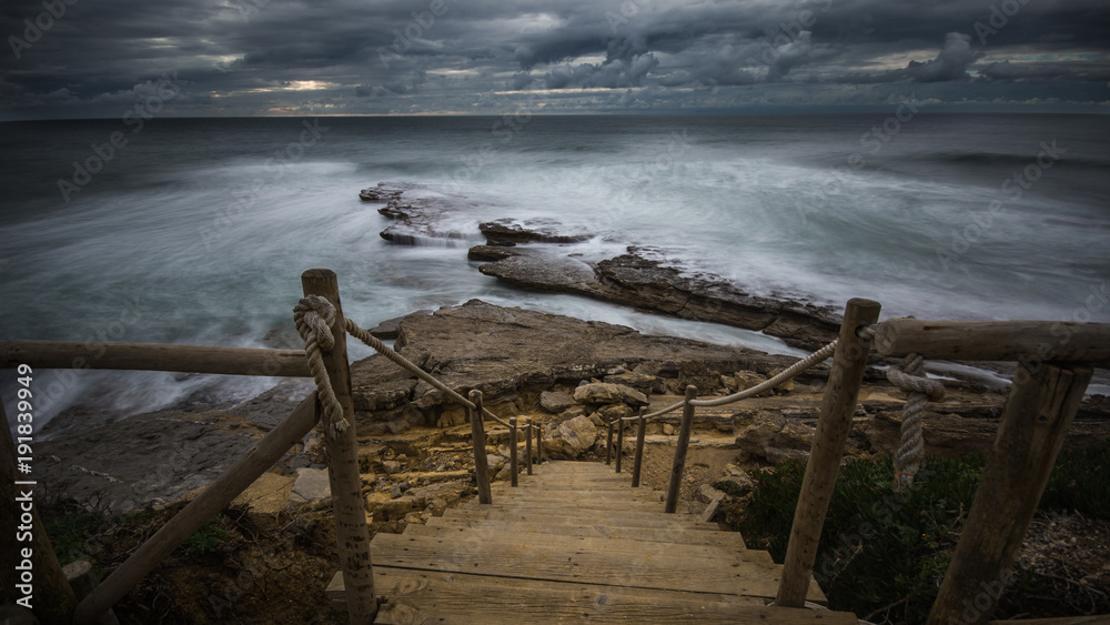 Beautiful rocky beach in the Portuguese coastline in a stormy day. Seascape. Long exposure. Beautiful rocky beach in the Portuguese coastline in a stormy day. Seascape. Long exposure.
