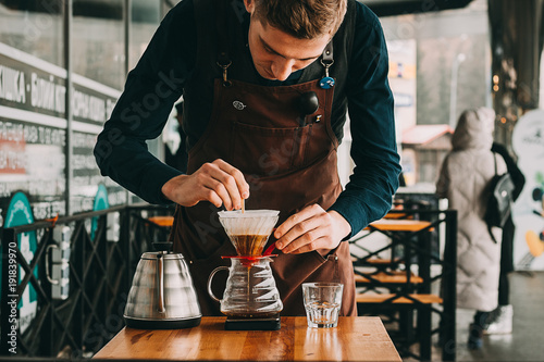 Barista making coffee in coffeeshop photo