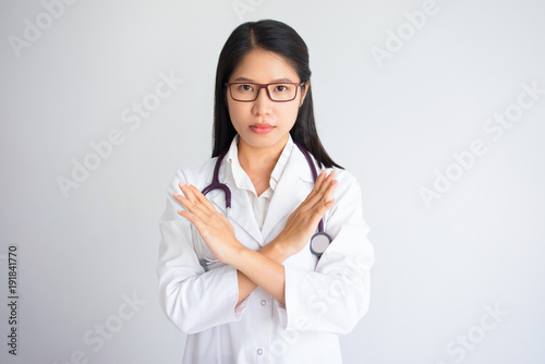 Strict Female Doctor with Forbidding Gesture