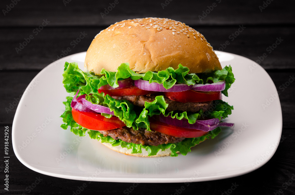 Burger served in bun in nutrition fast food concept Burger served in bun in nutrition fast food concept
