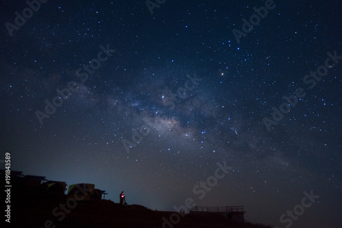 Landscape with milky way, Night sky with stars and silhouette of a standing man on Phutabberk Phetchabun in Thailand