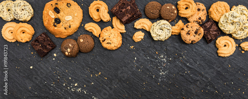 Top view different cookies on table top, Flat lay of various cookies on black stone for background, Prepared cookies food buffet on table for serve
