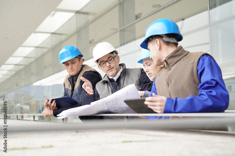 Construction manager giving instructions to training students Construction manager giving instructions to training students