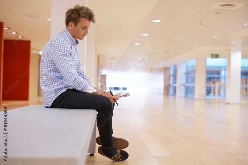 20-year-old student sitting on bench in school hall 20-year-old student sitting on bench in school hall