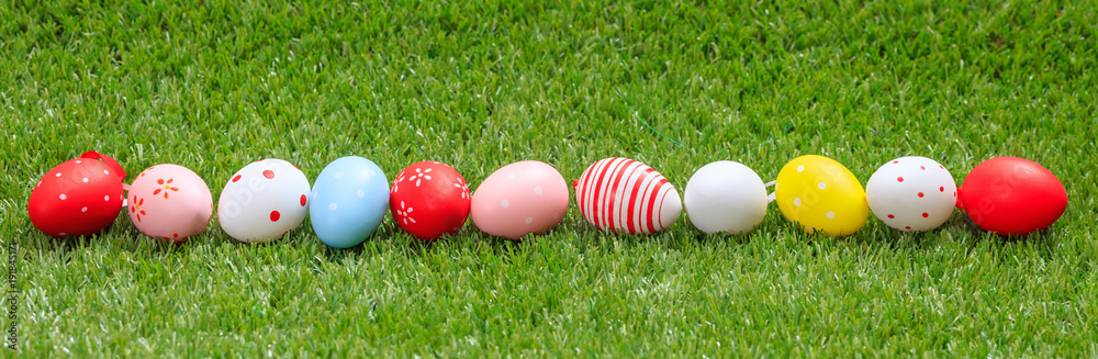 Easter concept. Colorful eggs on green grass, banner, copy space Easter concept. Colorful eggs on green grass, banner, copy space