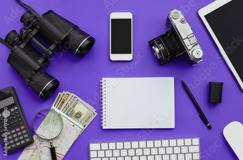 Flat lay of accessories on violet desk background