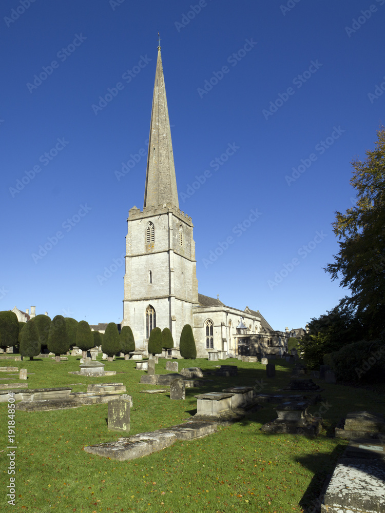 The historic church and churchyard yew trees at Painswick in the Cotswolds, Gloucestershire, UK. Wide-angle composite image.