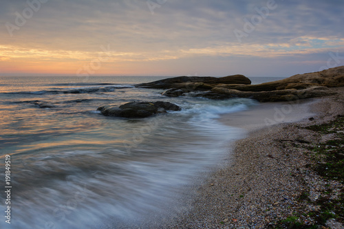 Sea sunrise at the Black Sea coast near Ravda  Bulgaria. Rocky sunrise