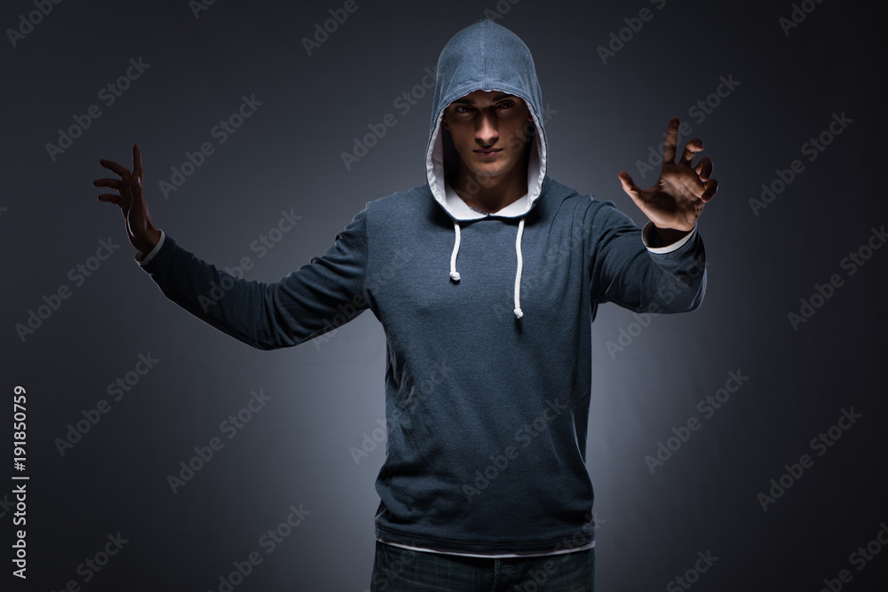 Young man wearing hoodie pressing virtual buttons