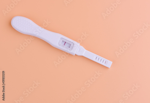 Pregnancy test with yellow background, health care concept.