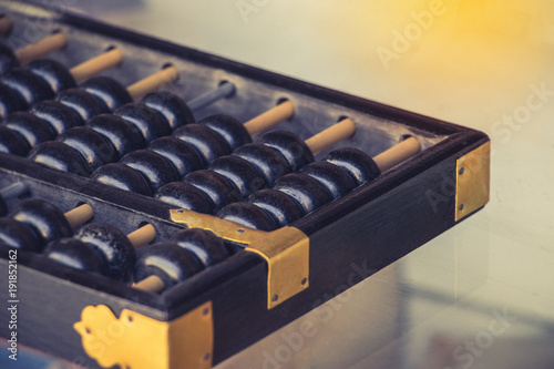 Close up of old vintage retro chinese abacus on wooden table with copy space for background. Vintage chinese abacus counting for finance, business, accounting. photo