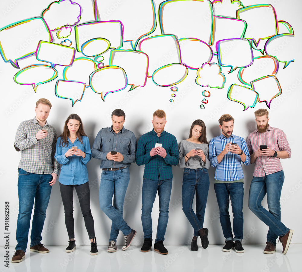 Fototapeta premium Group of boys and girls connected with their smartphones. Concept of internet and social network