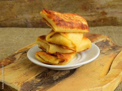  Pancakes are put by the hill on a plate. Pancakes have stuffing. Traditional dish of Belarusian cuisine