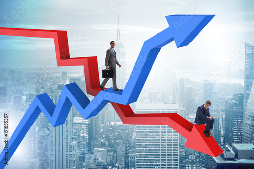 Businessman with charts of growth and decline