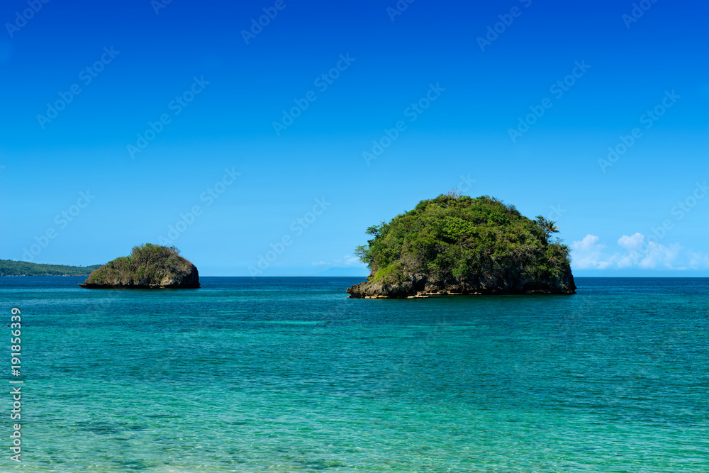 Two small islands on tropic turquoise sea.