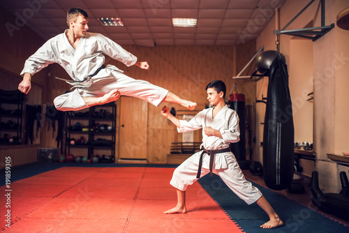 Fotografia, Obraz Martial arts masters practice kick in jump