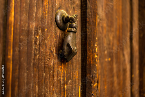 Obraz na plátně Old  wooden door with ancient iron knockers