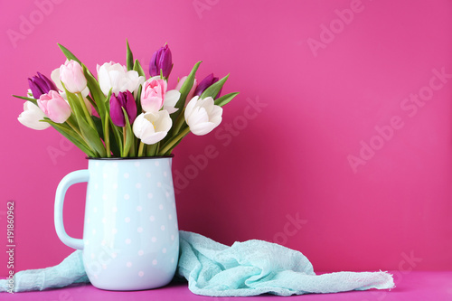 Fototapeta Naklejka Na Ścianę i Meble -  Bouquet of tulips in jug on pink background