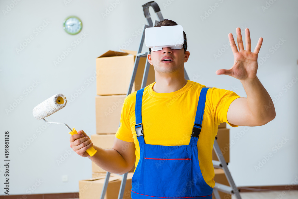 Painter contractor working with virtual reality goggles Painter contractor working with virtual reality goggles