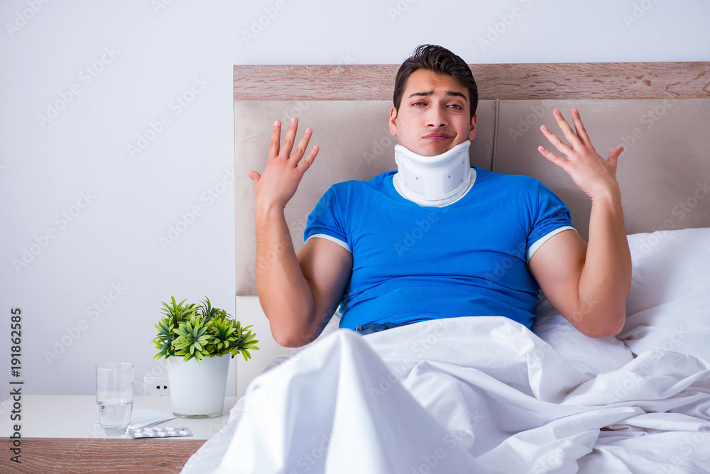 Young man with neck injury in the bed Young man with neck injury in the bed