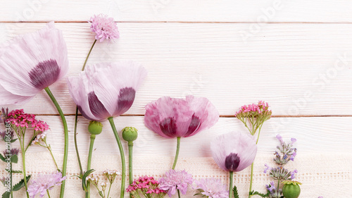 Field flowers of pink color  poppies  yarrow  scabiosa  festive composition on wooden board  desk Overhead top view  flat lay. Copy space. Birthday  Mother s  Valentines  Women s  Wedding Day concept