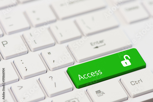 Green key with text Access and open padlock icon on white laptop keyboard