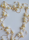 elegant gold necklace with white pearls.decoration. beautiful romantic holiday frame, background