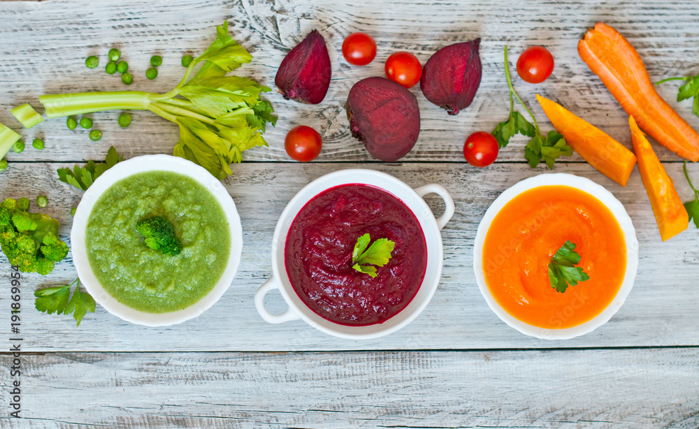 Variety of colorful vegetables cream soups and ingredients for soup. Top view. concept of vegetarian food Variety of colorful vegetables cream soups and ingredients for soup. Top view. concept of vegetarian food