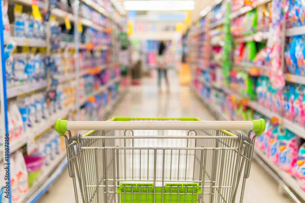 Supermarket store abstract blur background with shopping cart, Supermarket aisle with empty shopping cart