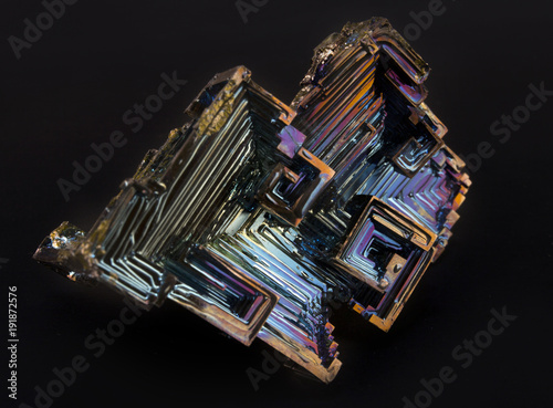 Shiny colorful mineral bismuth on a dark background photo