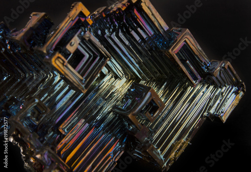 Shiny colorful mineral bismuth on a dark background photo