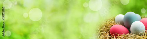 Green bokeh background with easter eggs