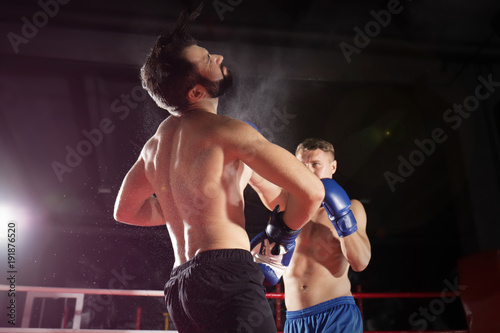 Young professional boxers training in ring © Africa Studio
