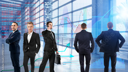 Team of brokers and stock exchange quotes on background