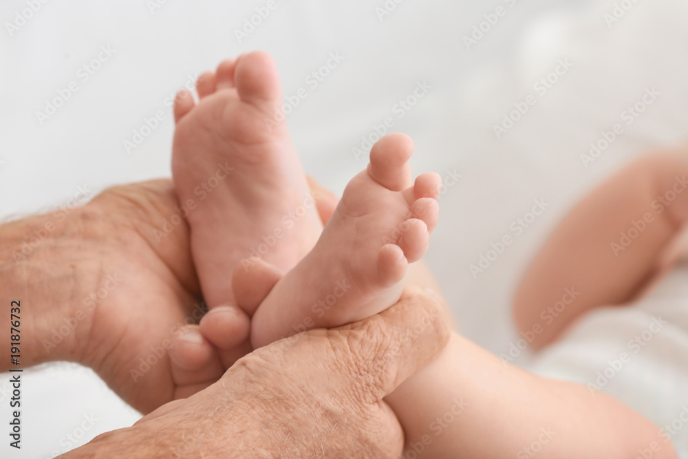 Senior man playing with his little grandchild at home, closeup Senior man playing with his little grandchild at home, closeup