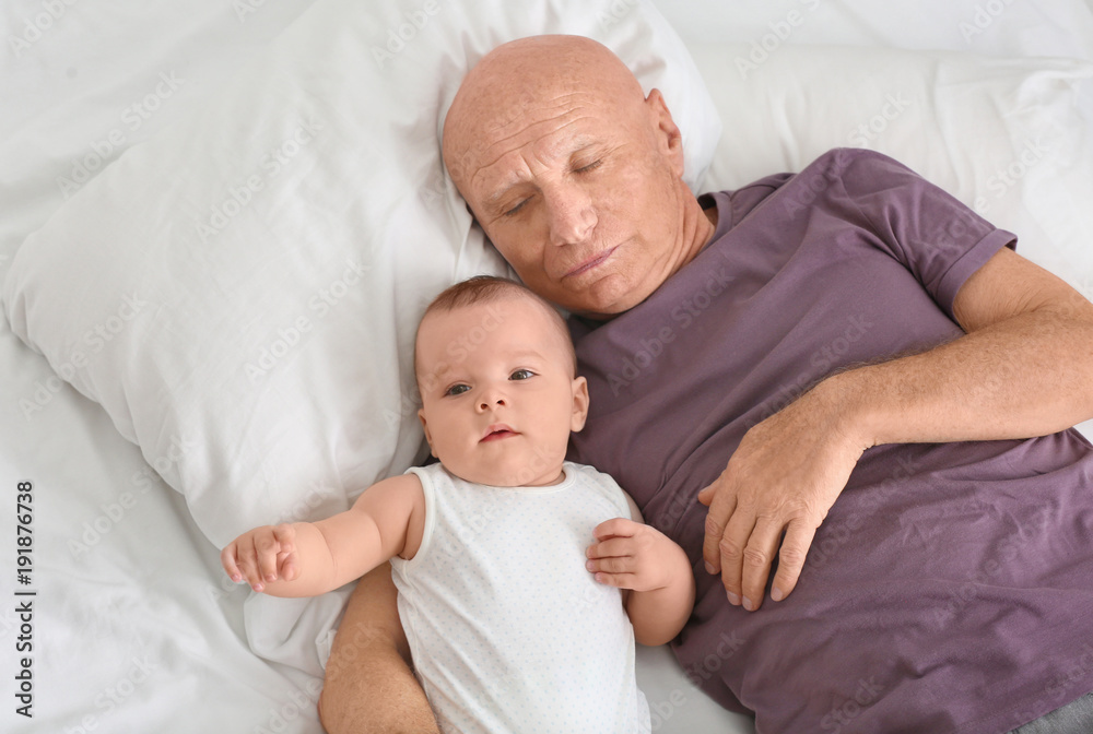 Senior man with his little grandchild resting at home Senior man with his little grandchild resting at home