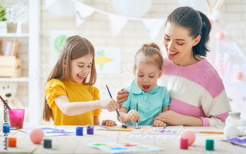 Mother and daughters painting together