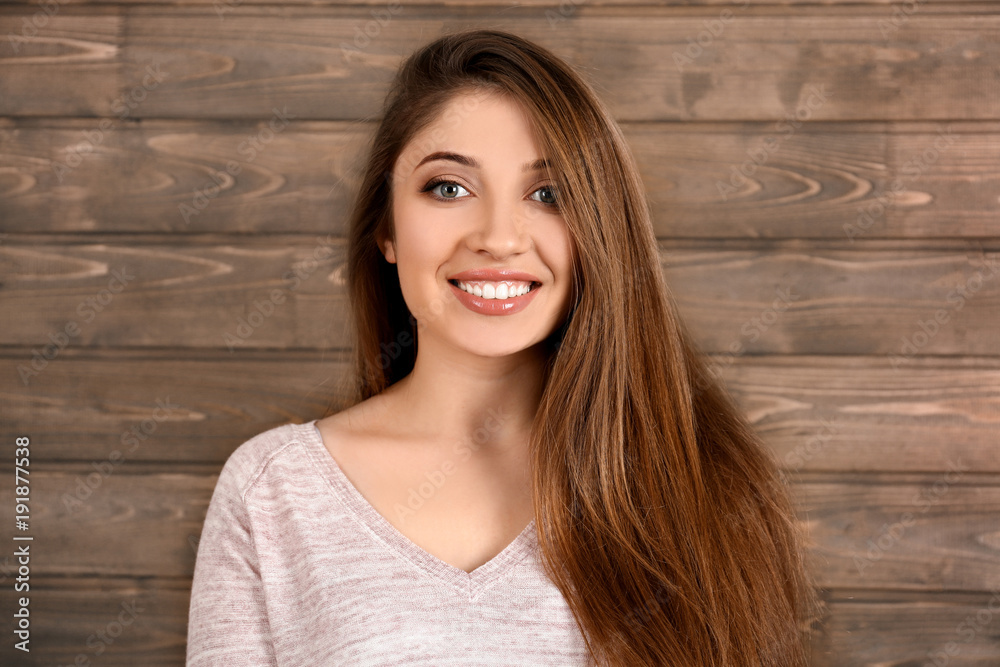 Portrait of beautiful smiling woman on wooden background Portrait of beautiful smiling woman on wooden background