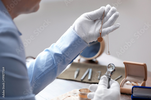 Jeweler working in workshop, closeup photo