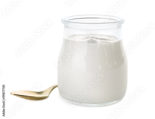 Jar with tasty yogurt and spoon on white background