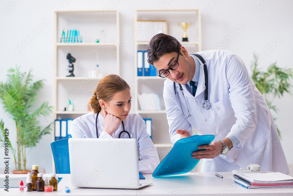 Male and female doctor having discussion in hospital Male and female doctor having discussion in hospital