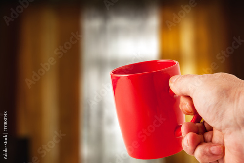 red cup, blurry window background