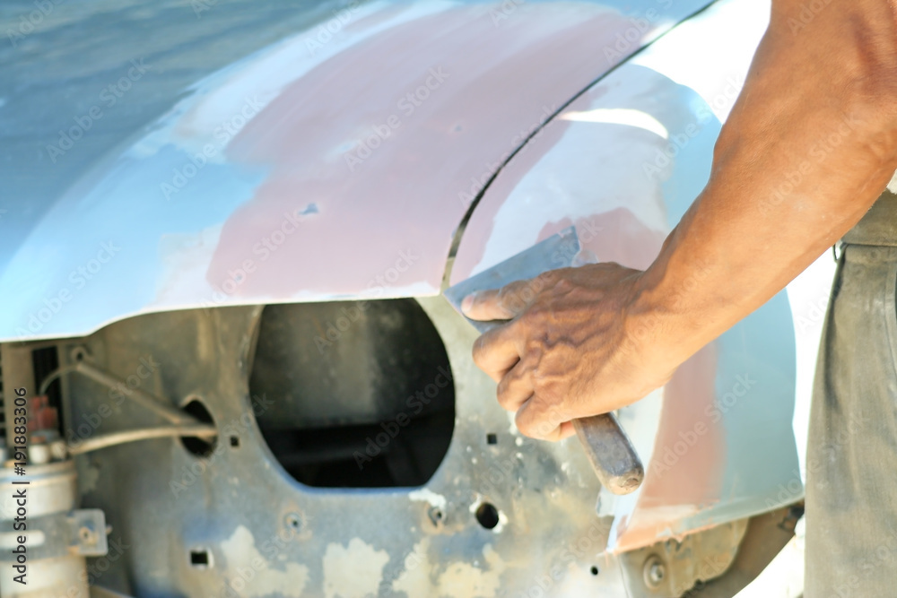 Automotive paint technician using paint on putty knife at , A