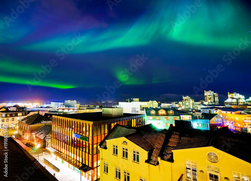 View of the northern light from the city center in Reykjavik, Iceland. photo