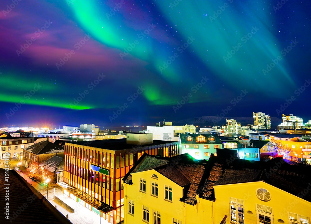 View of the northern light from the city center in Reykjavik, Iceland. - obrazy, fototapety, plakaty 